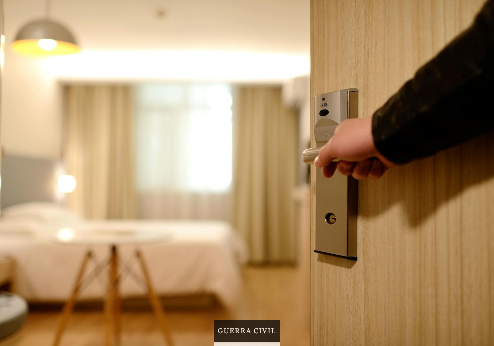 Person Holding on Door Lever Inside Room